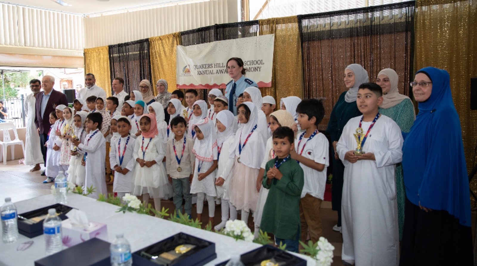 A teacher working with young Arabic School students